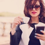 young-woman-drinking-coffee-smartphone