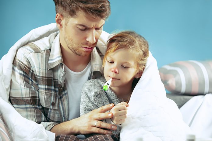 Sick man with daughter at home. The ill family.