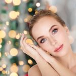 beautiful woman face over christmas lights
