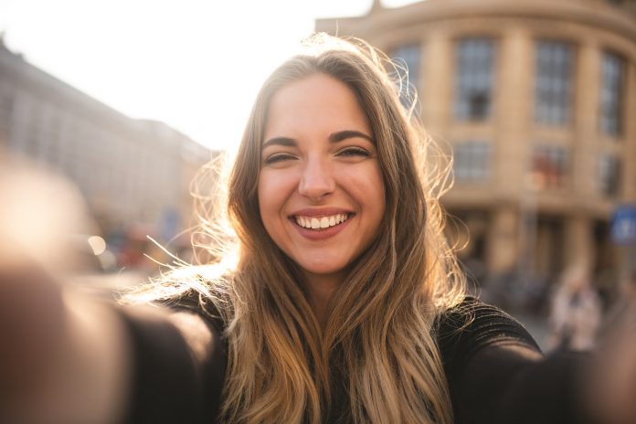 Attractive woman posing in front of camera lens