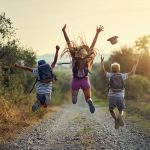 Happy little hikers jumping with joy