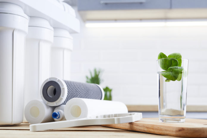 A,Glass,Of,Clean,Water,With,Osmosis,Filter,And,Cartridges