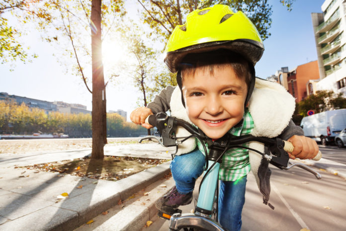 Smiling,Boy,In,Safety,Helmet,Riding,His,Bike