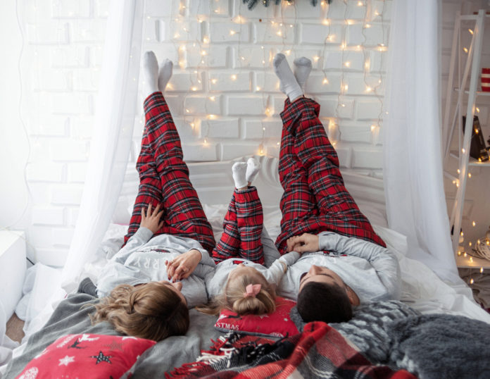 Happy,Funny,Family,With,Their,Daughter,In,The,Bedroom,In