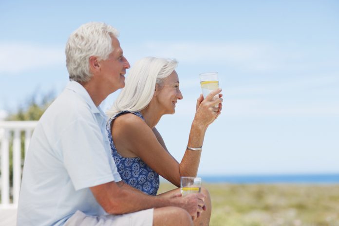 Senior couple drinking water on beach