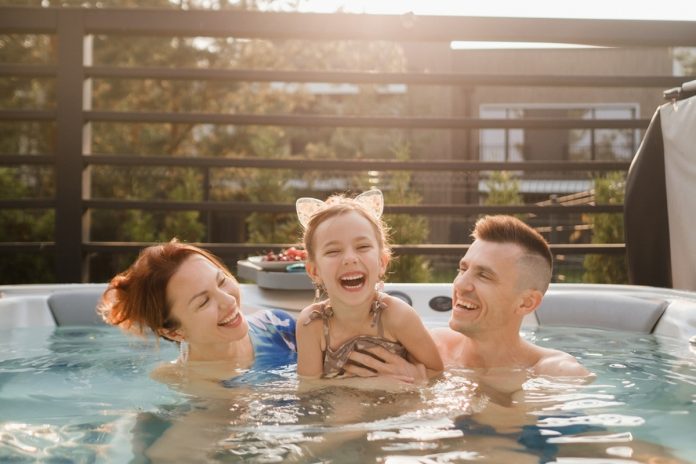 In,Summer,,The,Family,Rests,In,The,Outdoor,Hot,Tub.