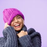 young-beautiful-fair-haired-woman-knited-hat-sweater-smiling-winking-violet