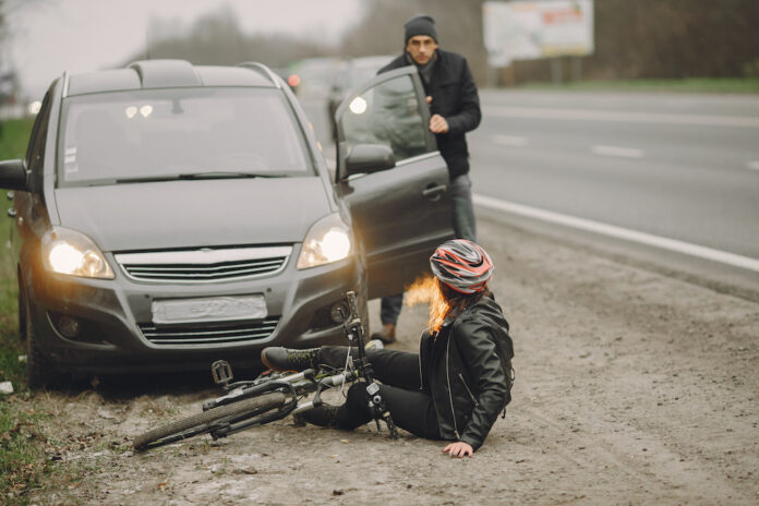 Road accident with cyclist man driver and car