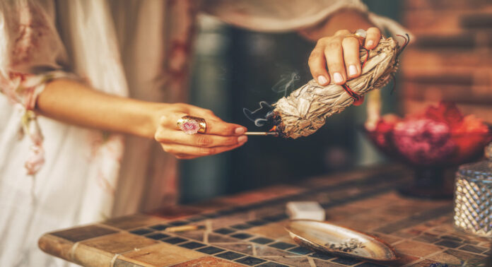 incense in a woman hand, ceremony space.